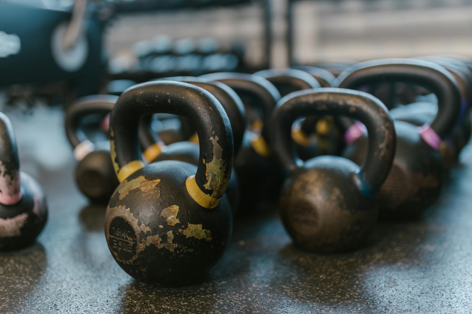 black and yellow kettlebell on gray concrete floor